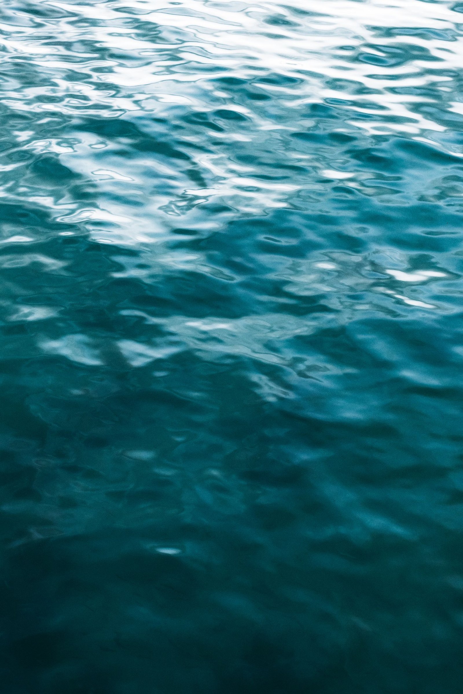 Close-up of clear blue ocean water creating a mesmerizing, serene pattern.